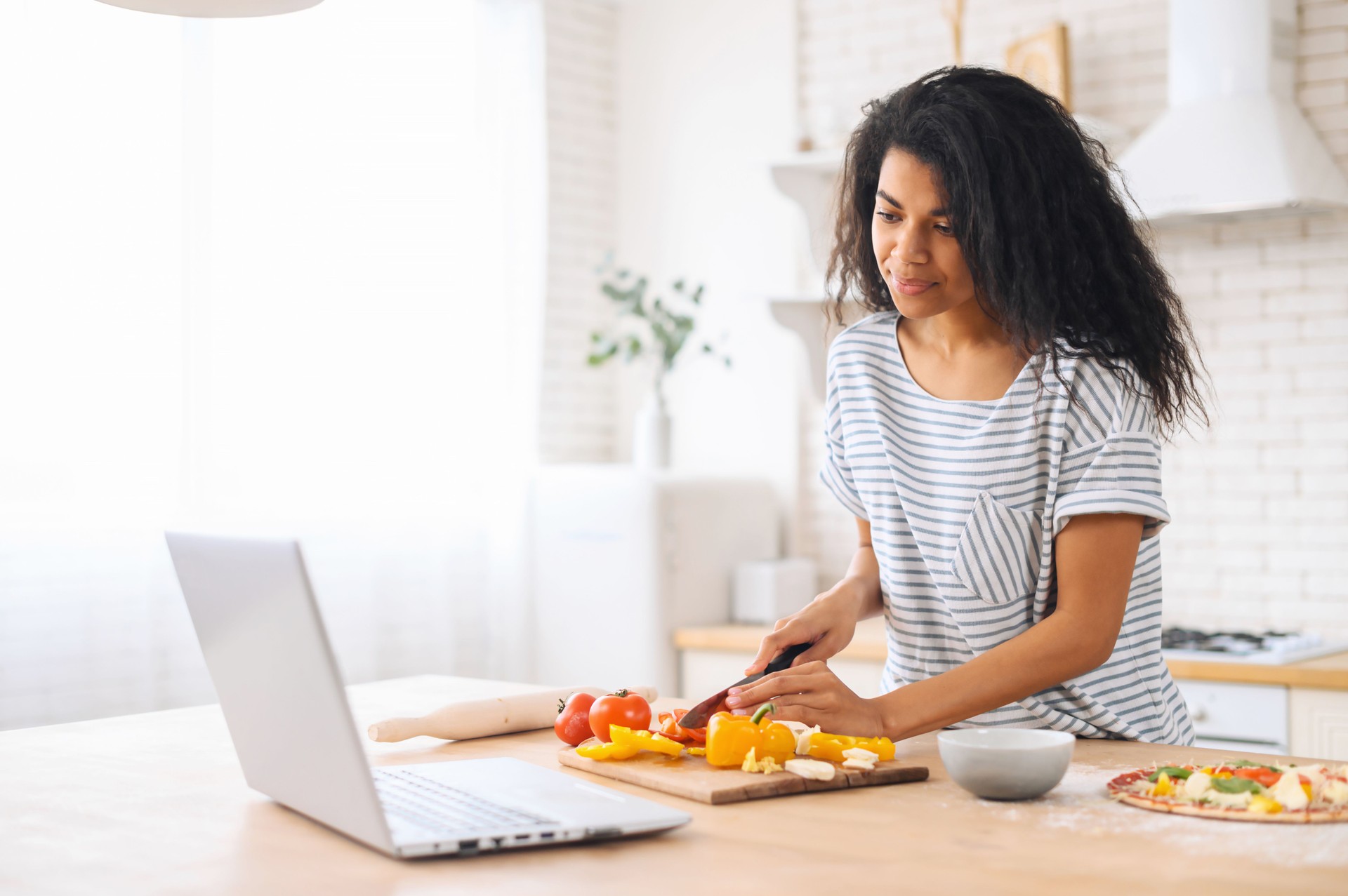Mixed-race young woman watching cooking classes